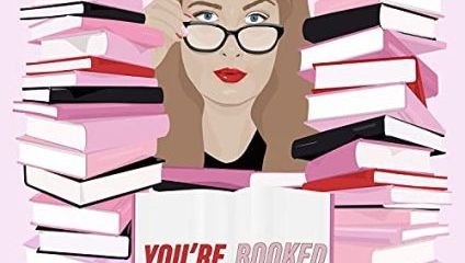 Illustration of a woman with glasses, holding a book, surrounded by piles of books. The text You're Booked is displayed on the open book in front of her. The background is pink, and the woman has a serious expression.