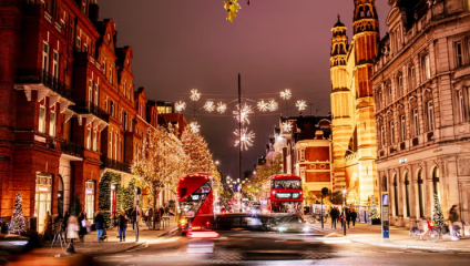 Night-time in Chelsea, and the Christmas lights illuminate the King’s Road as a red London bus head in each direction