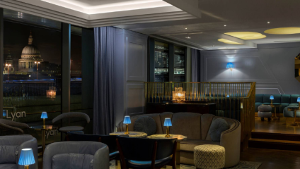 The cool interior of the Lyaness bar in London's Sea Containers' hotel, with St Paul's Cathedral visible against the night sky in the window