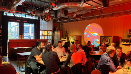 The interior of London's Spiritland bar; groups of men sit at multiple table under a high ceiling with a red and yellow decor