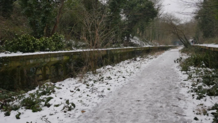 Snow has fallen thick on the ground of the Parkland Railway Walk in Haringey, London