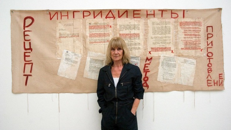 Image credit: Portrait of Barbara Steveni, stood with her work Banner, 1993. - Photo: John Mallinson. Courtesy Estate of Barbara Steveni