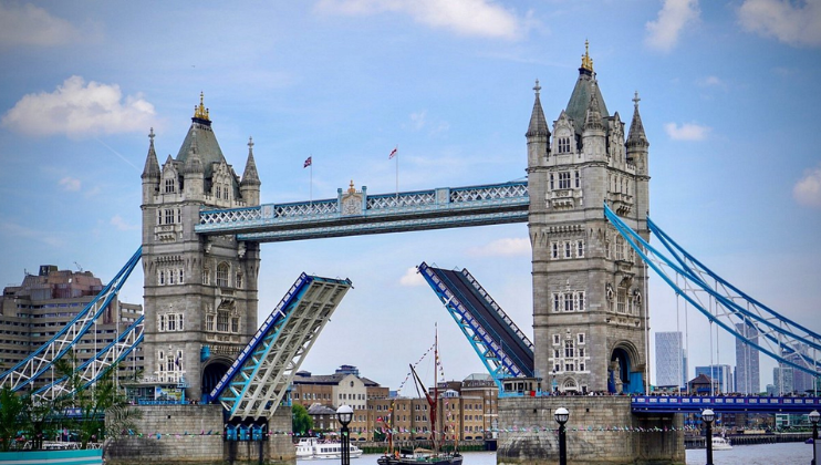 London’s iconic Tower Bridge stands tall against a bright blue sky