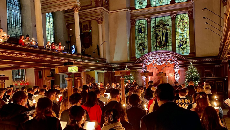 The congregation at St James Church in Piccadilly sing carols by candlelight