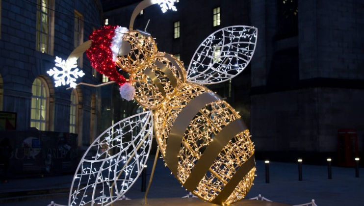 A Christmas light installation in Manchester city centre in the shape of a bumblebee wearing a Santa hat