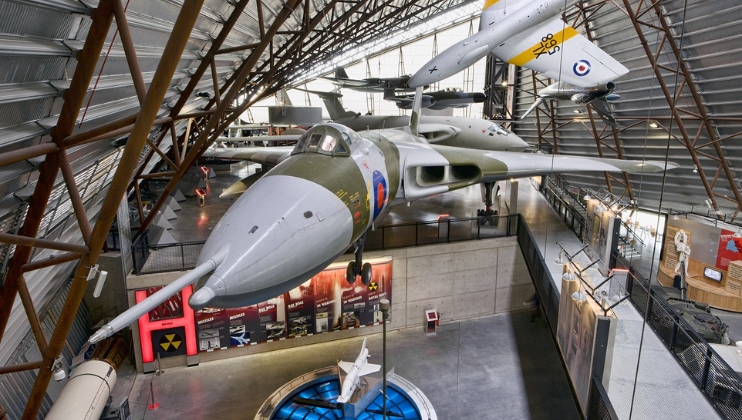 In Hangar 6 of the RAF Museum in London, several RAF planes are suspended from the ceiling above split-level viewing platforms.