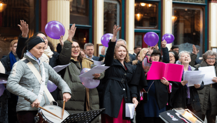 Music in Offices - women singing and playing instruments International Womens Day Celebration