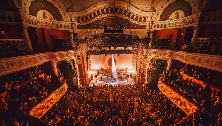 Revellers inside the grand and intimate auditorium of theO2 Shepherds Bush Empire watch a gig