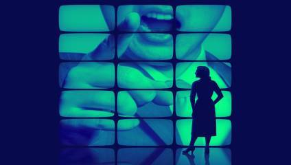 Silhouette of a person standing in front of a large screen displaying a close-up image of a person pointing and speaking. The screen is divided into multiple smaller panels, creating a composite effect. The colors are predominantly shades of blue and green.