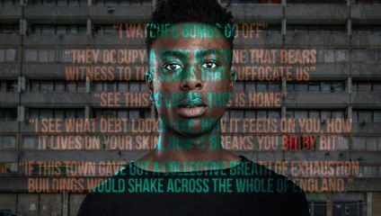 A person stands in front of a grey, multi-story building with a somber expression. Superimposed over the image are several fragmented, poetic phrases in various colors discussing themes of violence, debt, and the impact on a town and its residents.