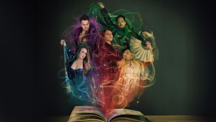 An open book emits colorful, ethereal light which swirls around five people dressed in elaborate, fantasy-inspired costumes. They pose dramatically as if performing, with colors corresponding to their attire: blue, green, red, purple, and orange.