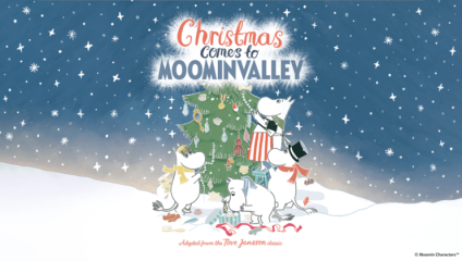 An illustrated Christmas scene from the Moomin series shows Moomin characters decorating a Christmas tree in a snowy landscape. The text at the top reads, Christmas comes to MOOMINVALLEY with a subtitle at the bottom, Adapted from the Tove Jansson classic.