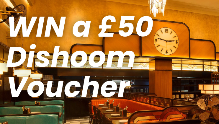 Image of a restaurant interior with teal seating and a large clock on the wall. Overlaying text reads WIN a £50 Dishoom Voucher in bold white letters. Warm lighting fills the space, creating a cozy atmosphere.