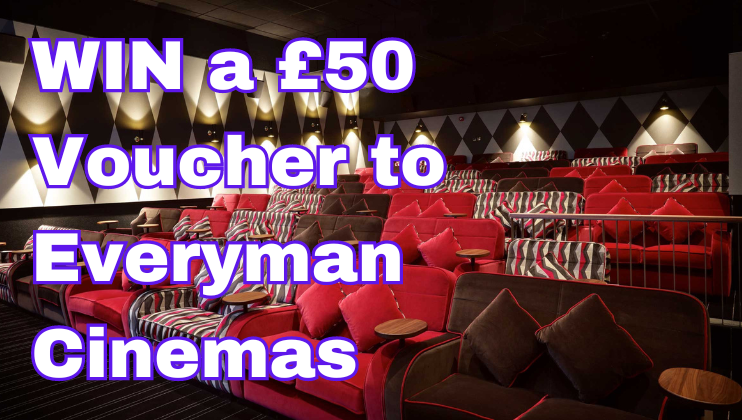 A cinema auditorium with red and black comfortable seats, all with small tables and cushions, and a sign over the image that reads, WIN a £50 Voucher to Everyman Cinemas in bold white letters with a purple outline.
